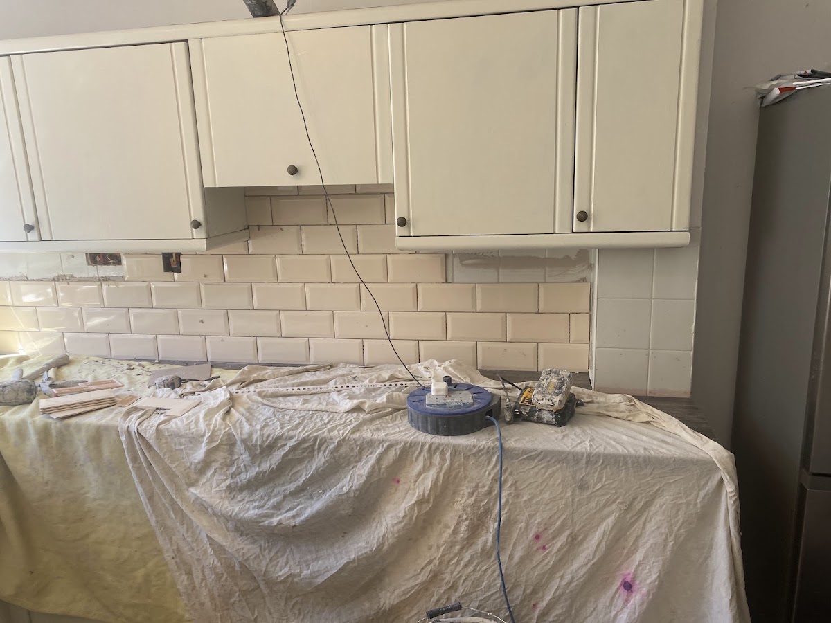 White metro kitchen splashback being installed