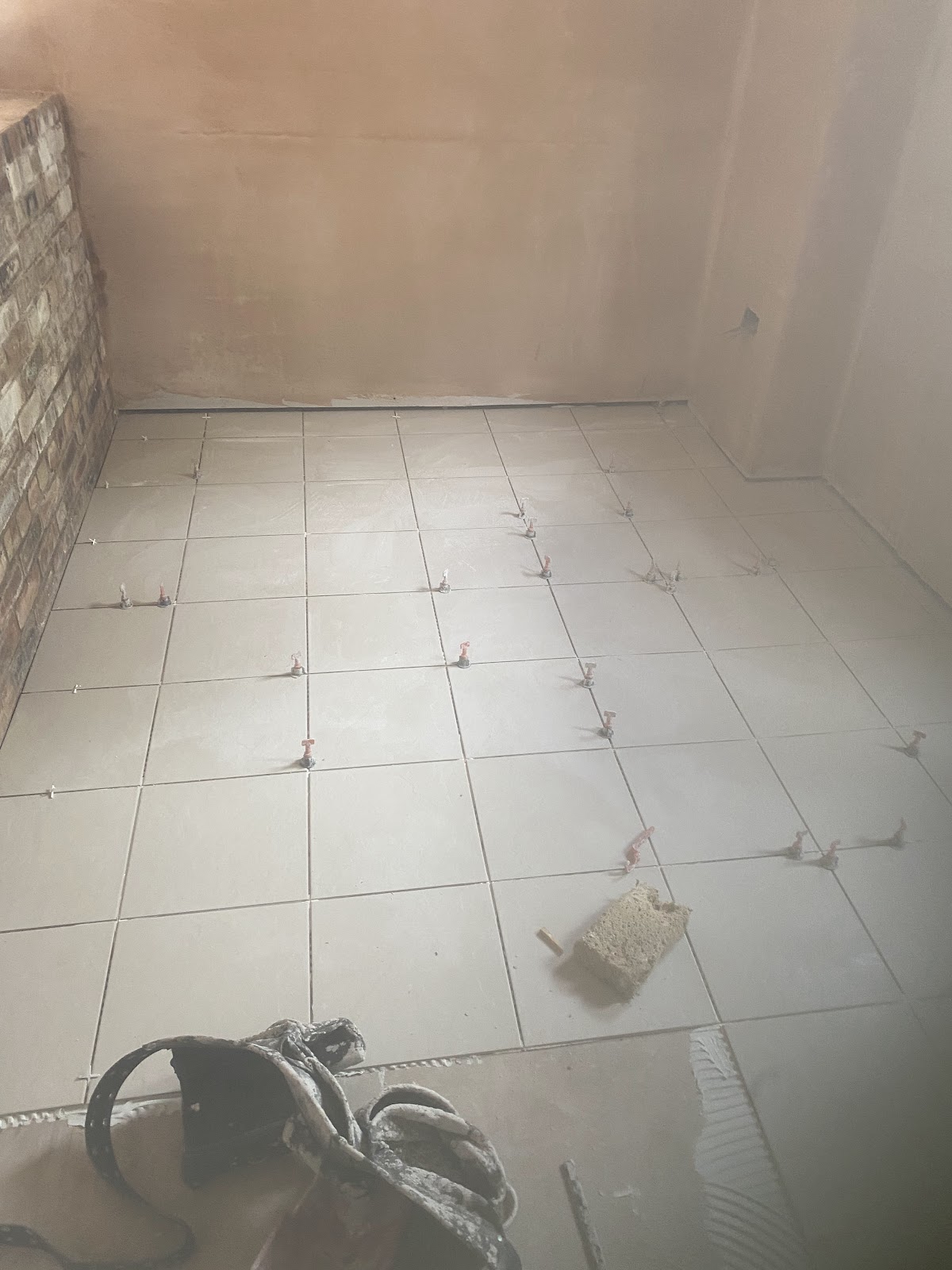 Porcelain floor being laid with tile spacers